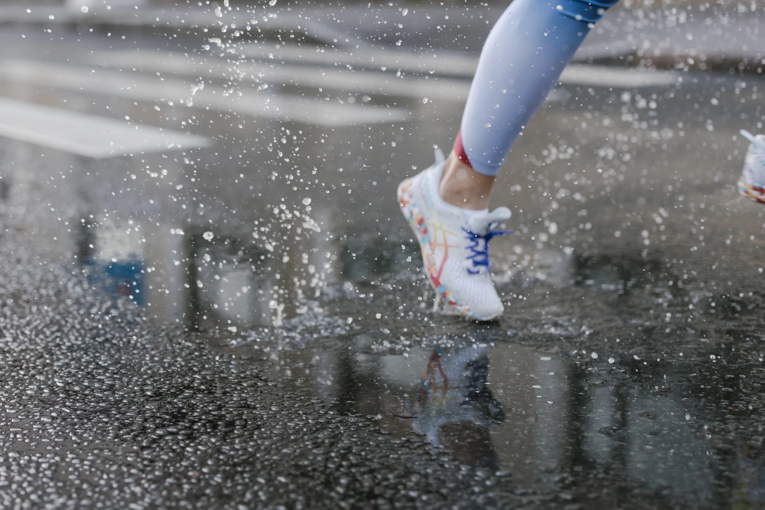 Runner splashing in rain